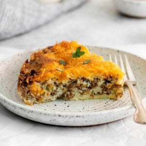 A slice of cheeseburger pie on a plate.