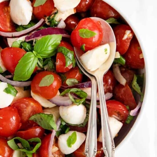 salad in bowl with spoons.