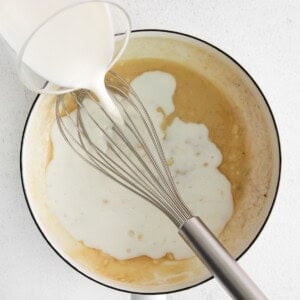 Pouring milk into a saucepan.