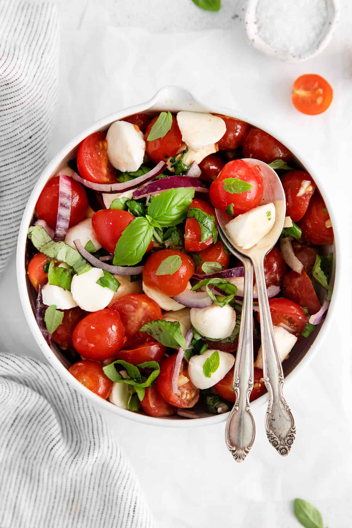 salad in bowl with spoons.