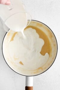 adding milk to pot.