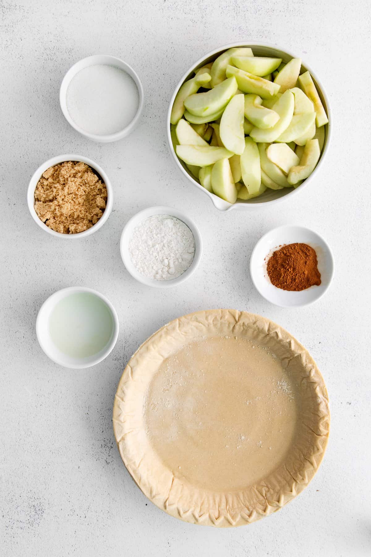 Ingredients for apple pie with cheese in bowls.