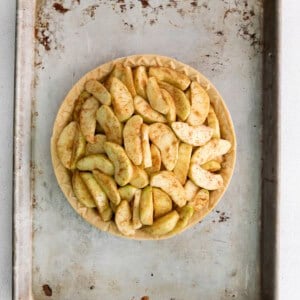 a pie with apples on a metal pan.