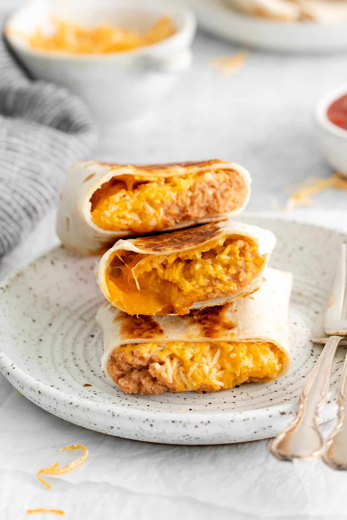 Bean and cheese burrito on a plate.