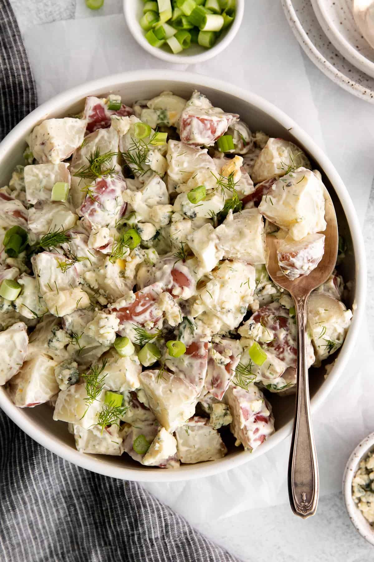 potato salad in bowl with spoon.
