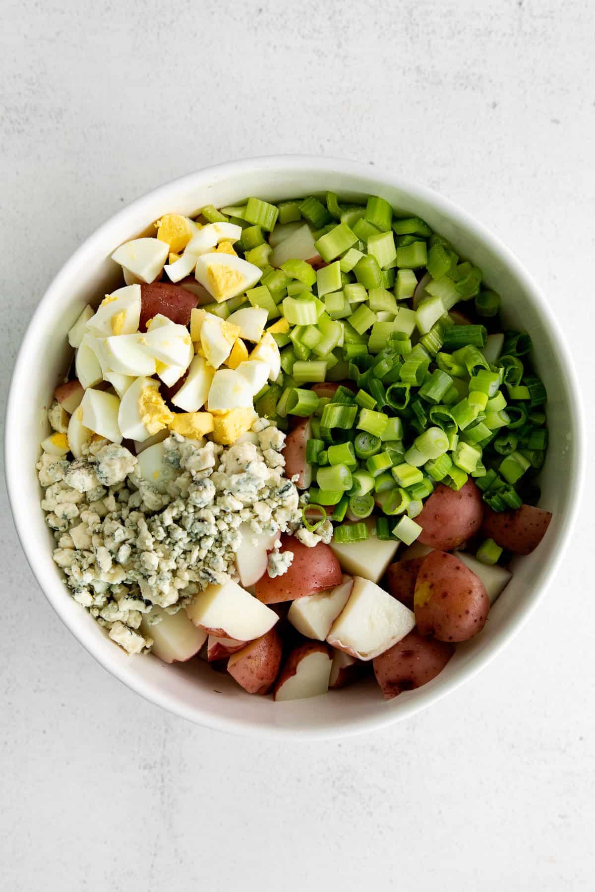 potato salad ingredients in bowl.