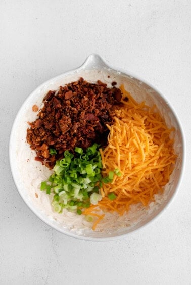 a white bowl filled with ingredients for a taco salad.