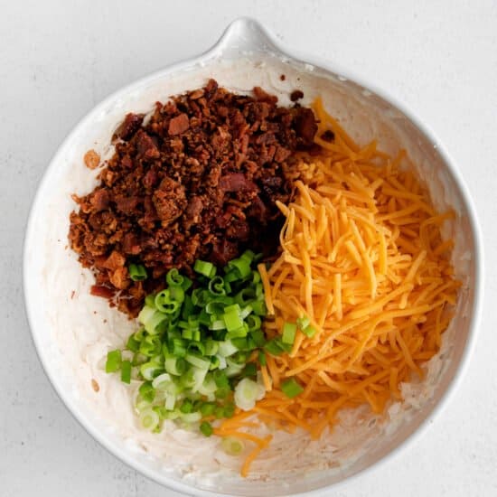 a white bowl filled with ingredients for a taco salad.