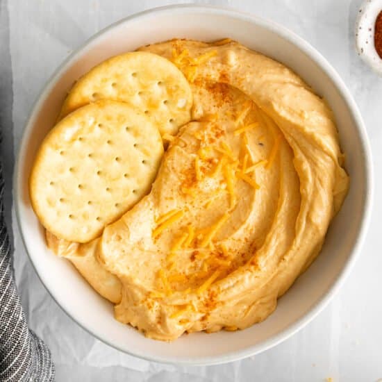 a bowl of hummus with crackers and crackers.