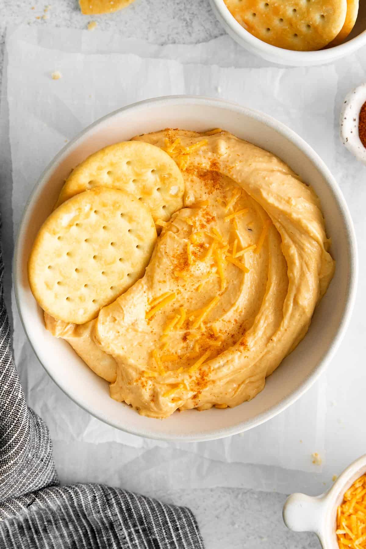 Homemade cheese spread in a bowl with crackers.