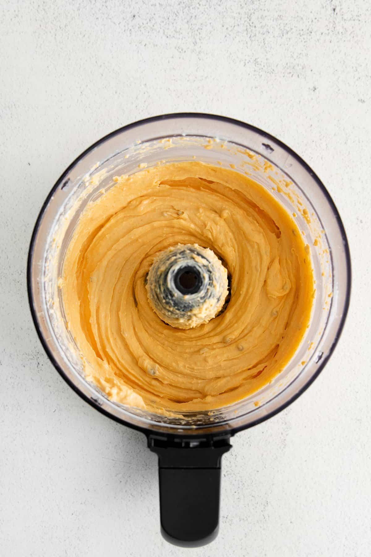 Homemade cheese spread in a food processor.