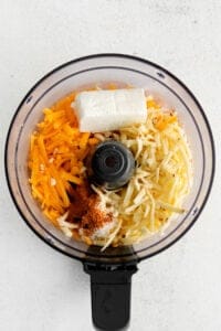 a food processor with various ingredients in it.
