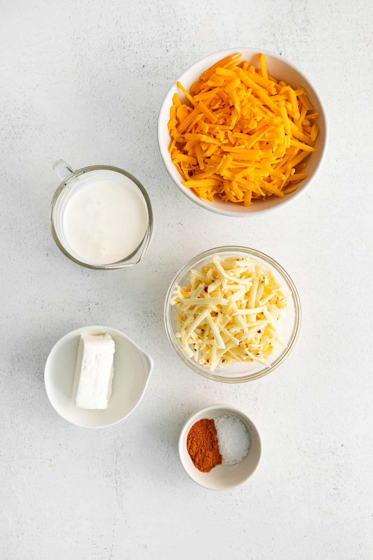 Ingredients for homemade cheese spread in bowls.