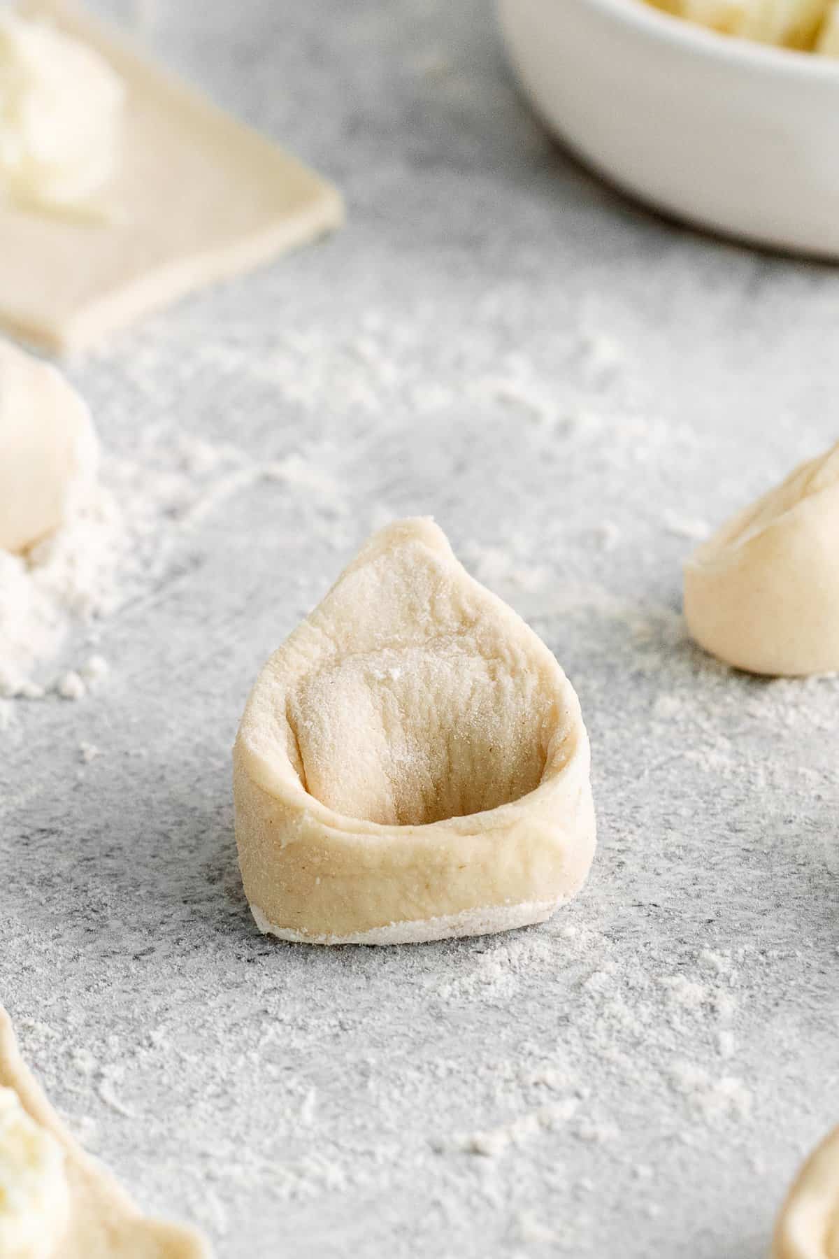 tortellini on cutting board.