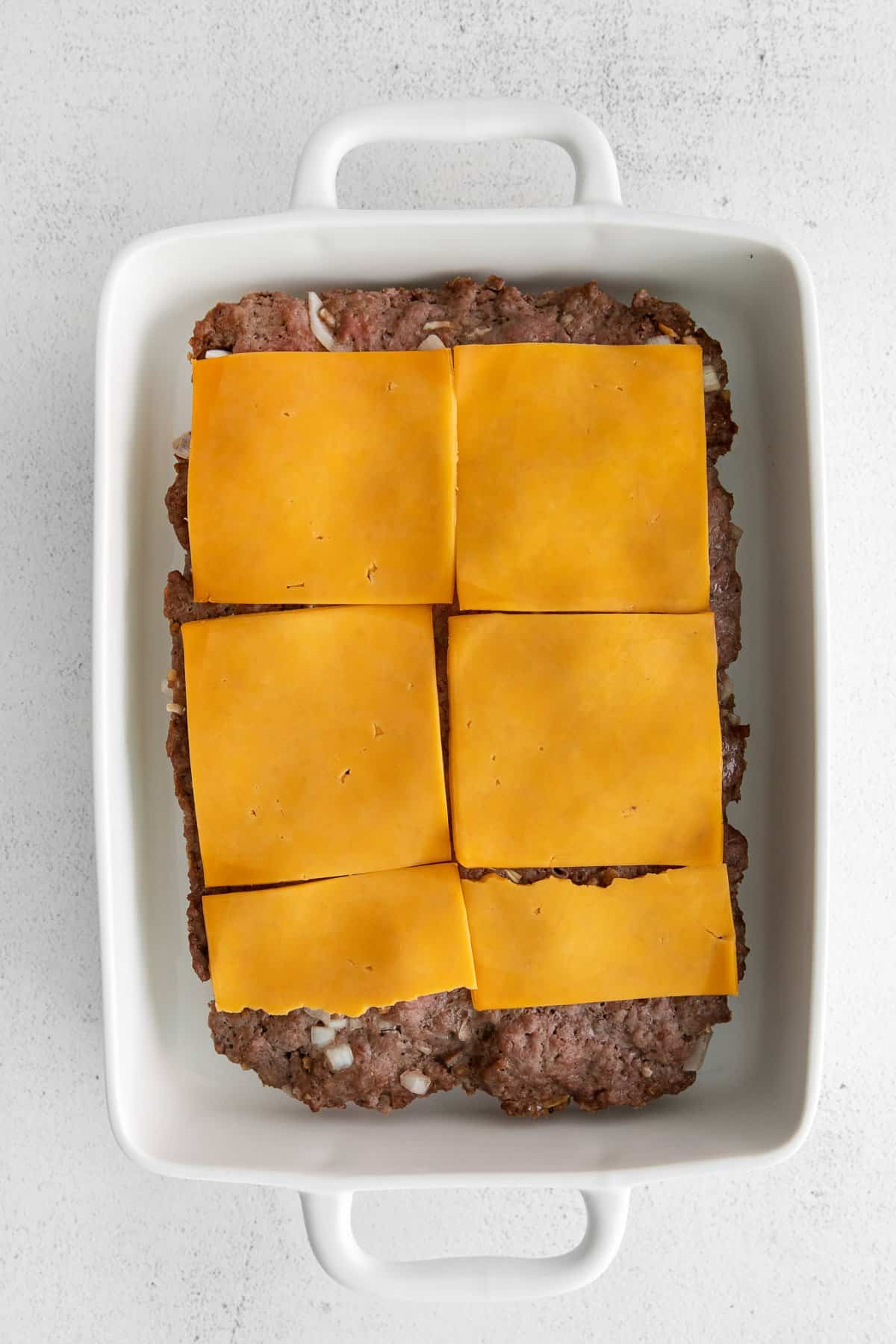 cheese on top of meat.