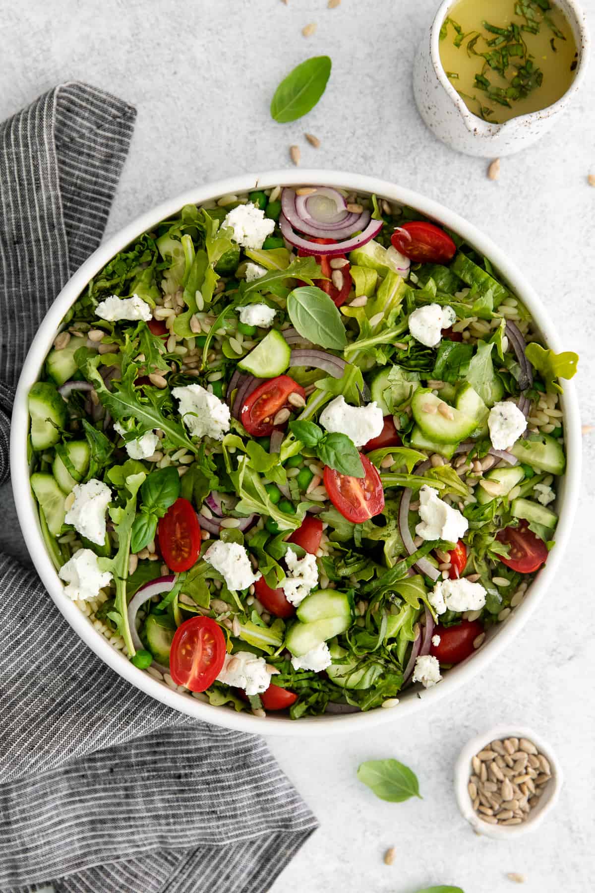 Lemon orzo salad with goat cheese in a bowl. 