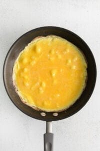 Whisked eggs in a skillet.
