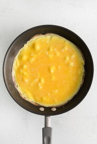 Whisked eggs in a skillet.
