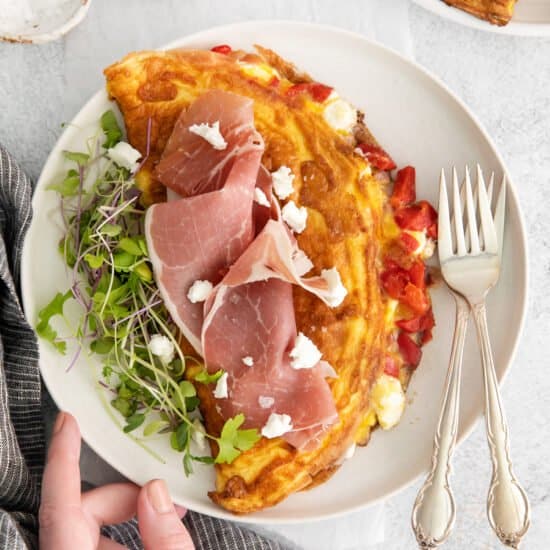 Prosciutto and goat cheese omelet on a plate.