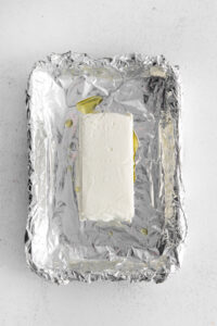 a piece of cheese on a piece of foil.