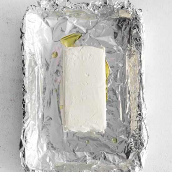 a piece of cheese on a piece of foil.
