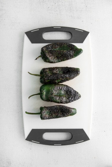 charred peppers on cutting board.