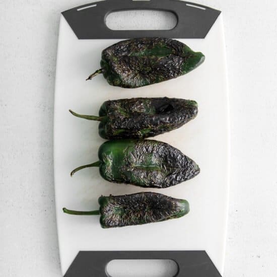 charred peppers on cutting board.