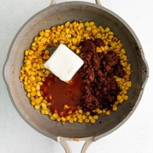 adding cheese to skillet.