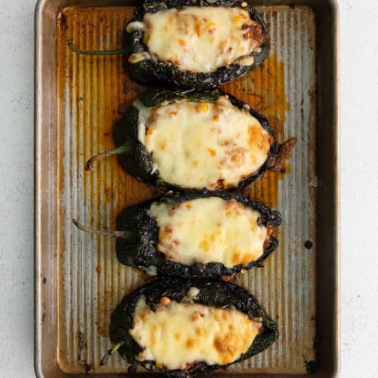 stuffed poblano peppers on baking sheet.
