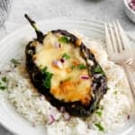 Stuffed poblano peppers served over rice.