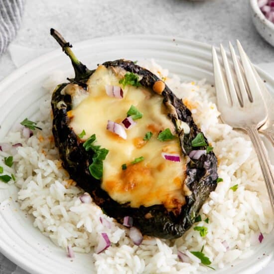 Stuffed poblano peppers served over rice.