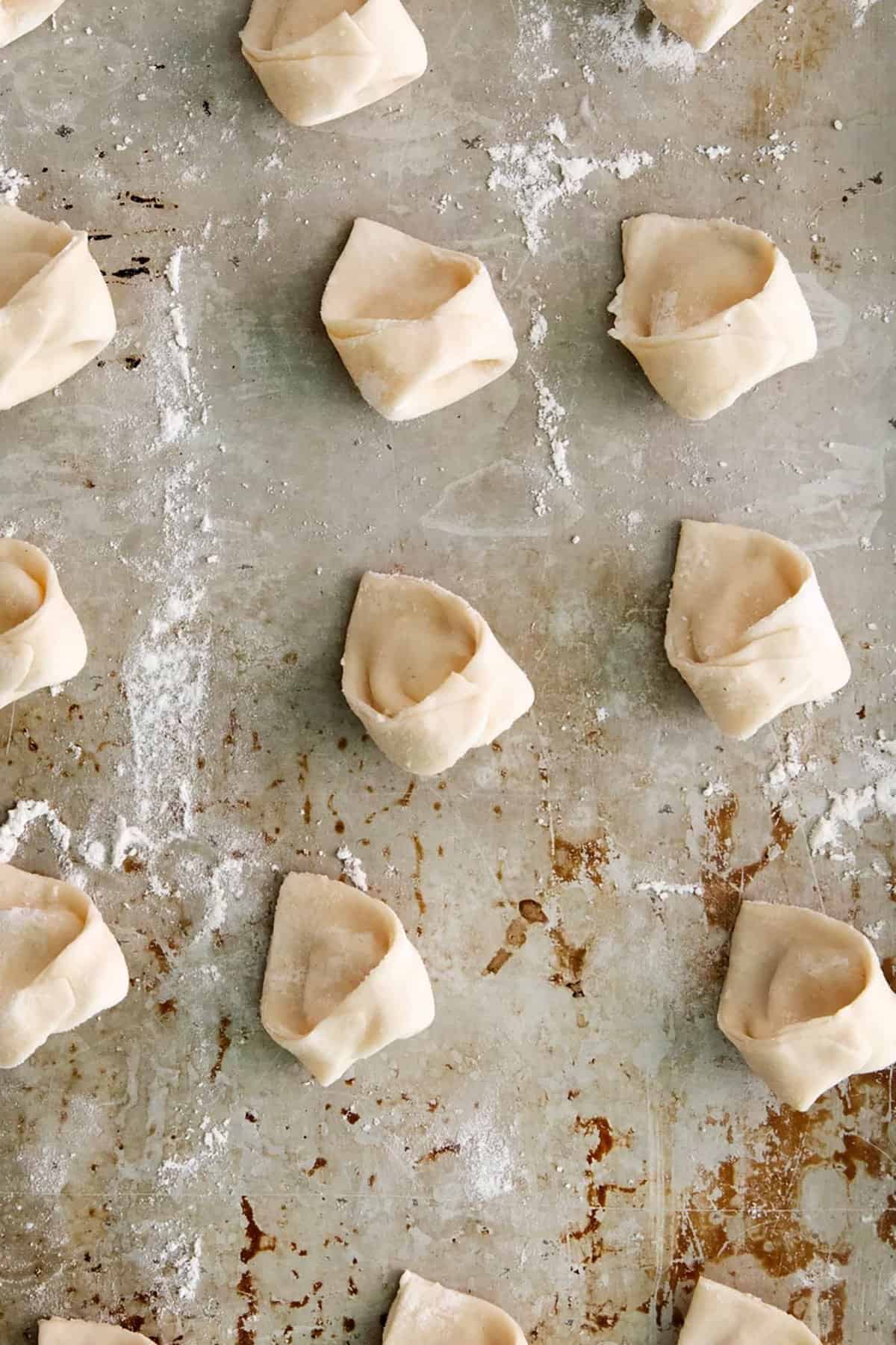 cheese tortellini on baking sheet. 