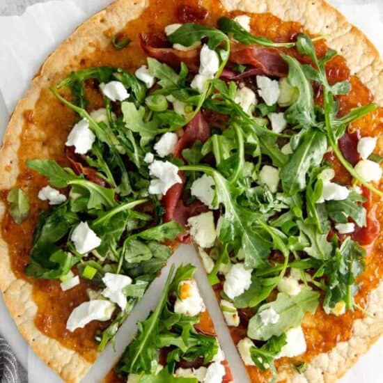 fig and goat cheese flatbread with a slice cut