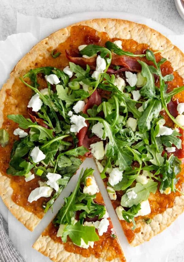 fig and goat cheese flatbread with a slice cut
