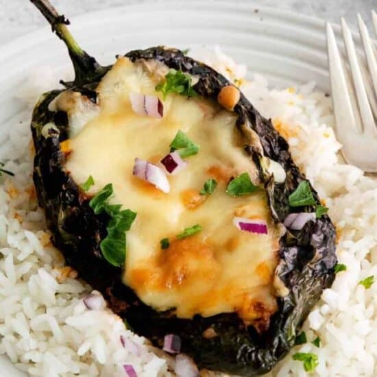 Stuffed poblano peppers served over rice.