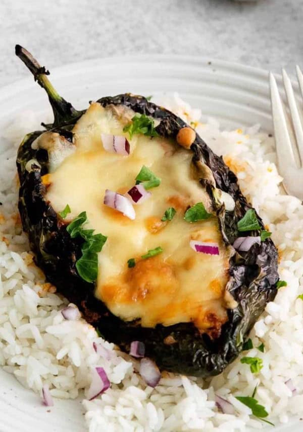 Stuffed poblano peppers served over rice.