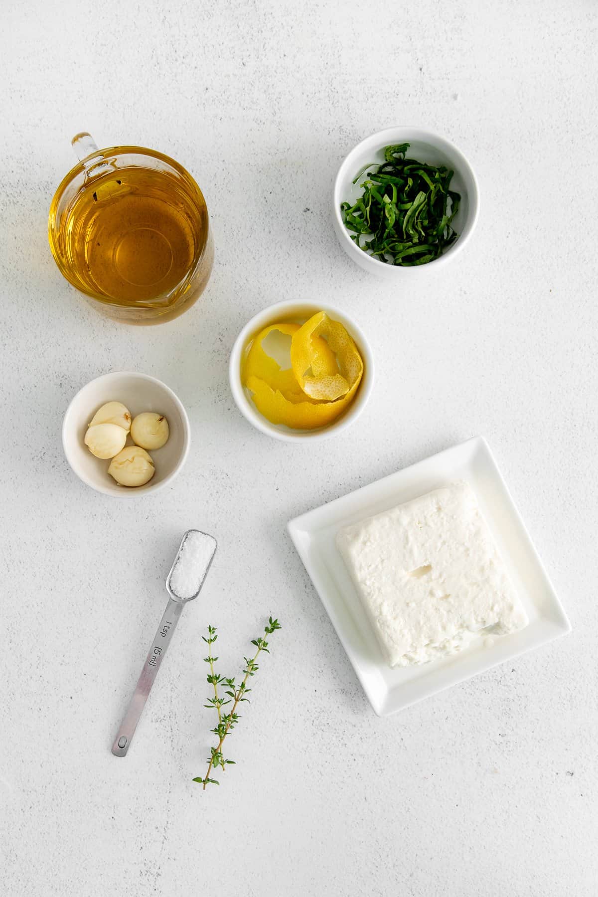 The ingredients for the marinaded feta in small dishes. 