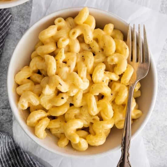 macaroni and cheese in a bowl with a fork.