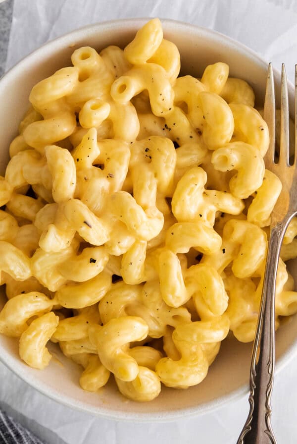 macaroni and cheese in a bowl with a fork.
