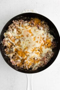 Melted cheese on top of cheeseburger dip.