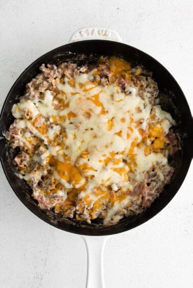 Melted cheese on top of cheeseburger dip.