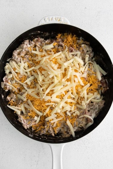 Cheeseburger dip topped with shredded cheese.