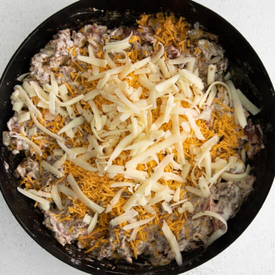 Cheeseburger dip topped with shredded cheese.