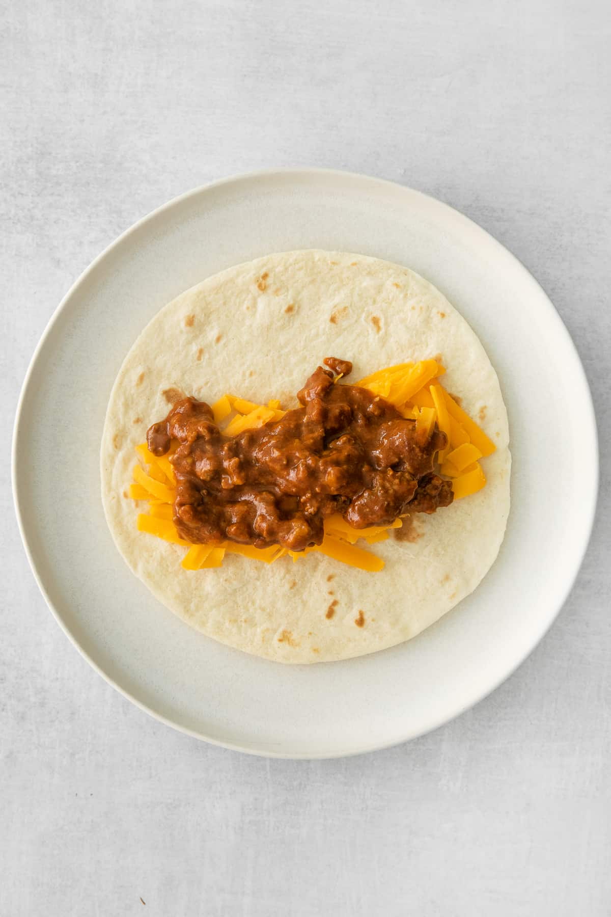 cheese and beef on tortilla.