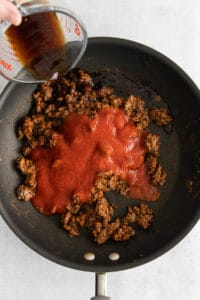tomato sauce and beef in skillet.