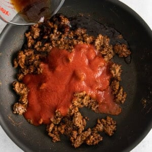 tomato sauce and beef in skillet.