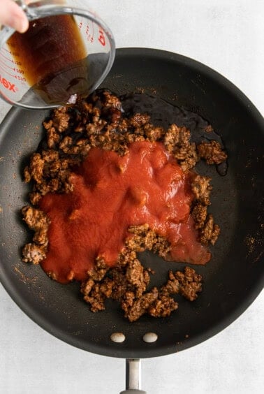 tomato sauce and beef in skillet.
