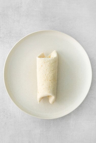 rolled burrito on plate.