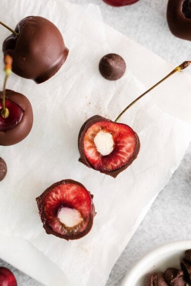 Pipped marscapone in the middle of pitted cherries.