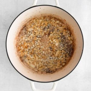 a pot filled with beans on a white background.